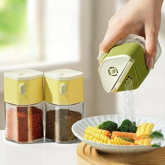 Hand pouring salt onto food using green push-button dispenser bottle