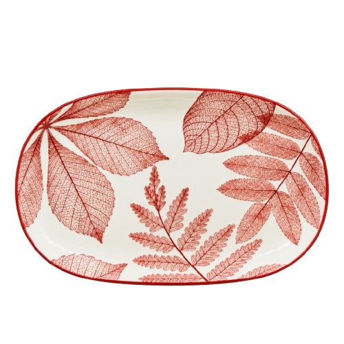 Close up of delicate red leaf texture design on white ceramic platter