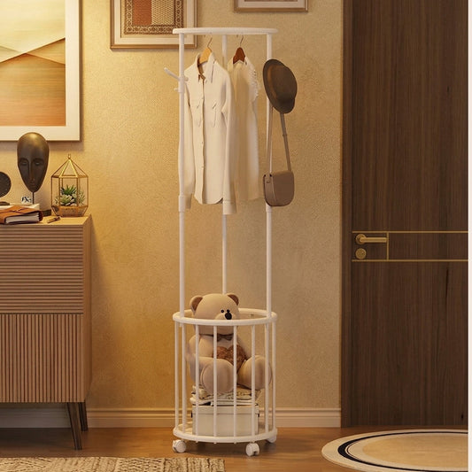 Modern white rolling clothes rack with storage basket holding a teddy bear in a home entryway