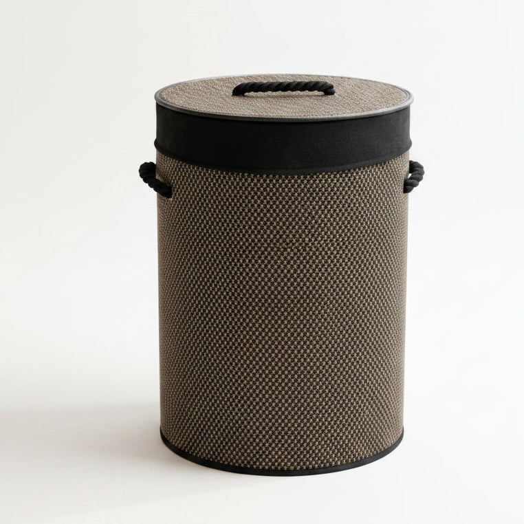 Round natural bamboo laundry basket with matching lid on wooden floor