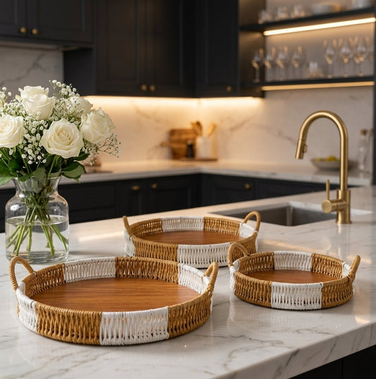 Set of 3 round handwoven rattan serving trays with wooden base on a marble kitchen island   
