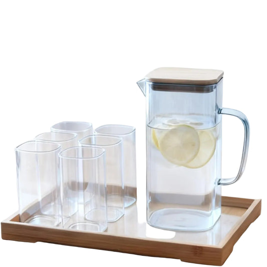 Square heat-resistant glass pitcher filled with lemon-infused water