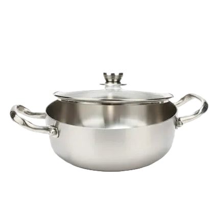 Stainless steel cooking pot with tempered glass lid placed on a white marble countertop.