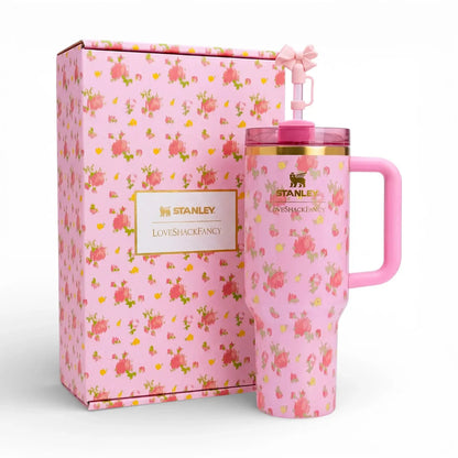 Pink Stanley Ibiza Sunset 40oz Quencher Tumbler next to matching floral packaging box on a kitchen marble counter