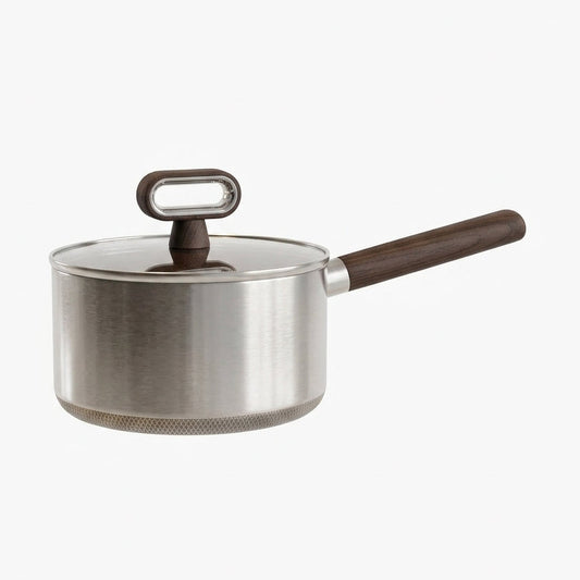 Titanium coated stainless steel saucepan with ergonomic wooden handle and glass lid on a white background