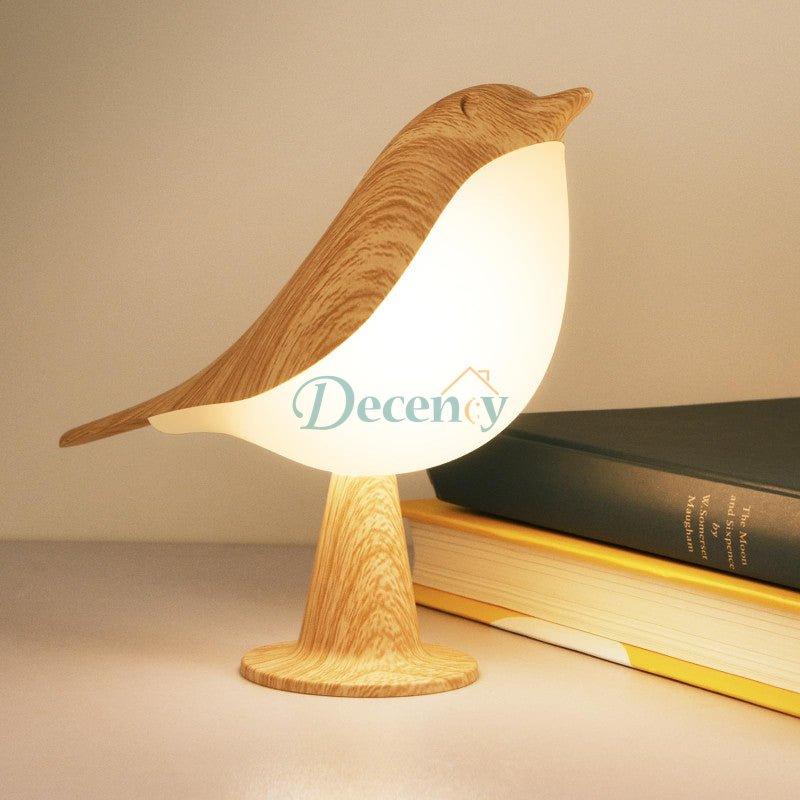 Touch LED bird lamp decorative night light with a warm glow on a bedroom bedside table.