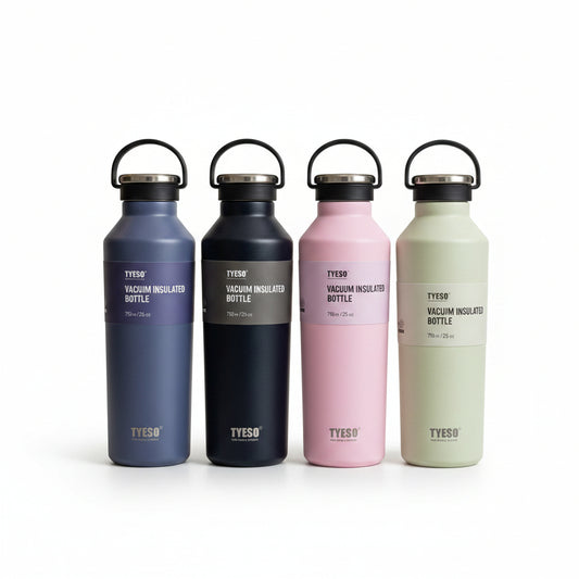 Four Tyeso 750ml vacuum insulated stainless steel water bottles lined up in pastel colors on a marble kitchen counter.