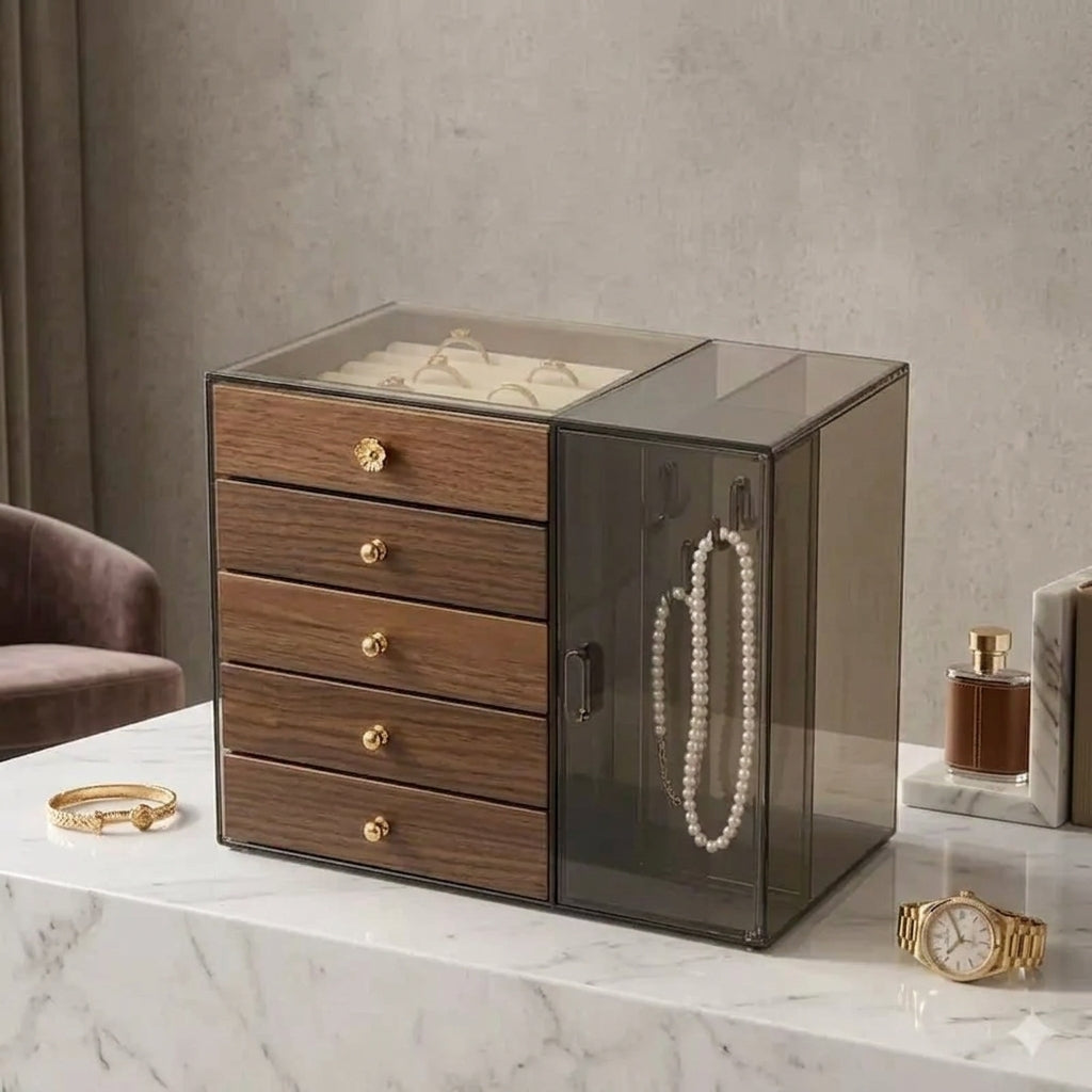 Front view of a luxury wooden jewelry organizer box with dark acrylic side cabinet and gold knobs on a marble table