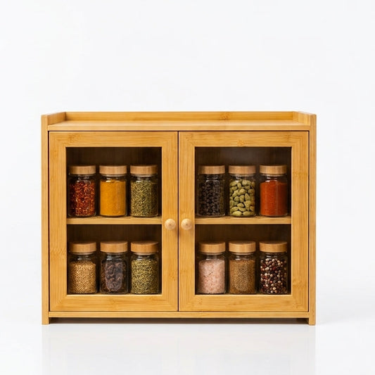 Wooden spice cabinet with clear acrylic doors holding 12 spice jars on a kitchen counter.   
